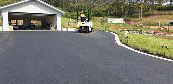 Final touches being made on a strip of asphalt.