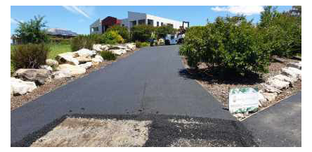 A strip of asphalt being worked on.